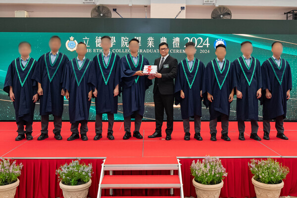 自強不息: 鄧炳強（右五）向修畢應用教育文憑的在囚人士頒發畢業證書。