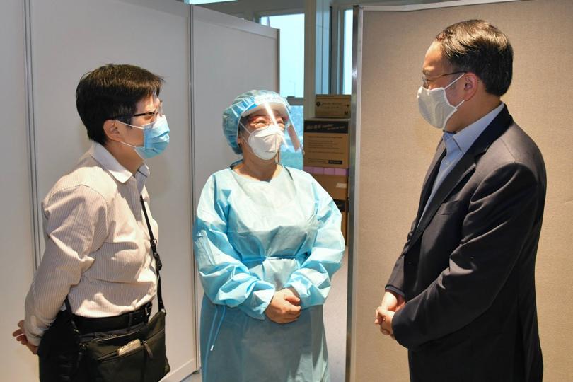 打氣:  許正宇（右）與社區檢測中心的工作人員交談，感謝他們協助推行普及社區檢測計劃。